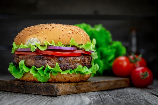 Fresh tasty burger on wood table