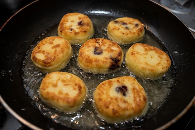 Fresh tasty cheese pancakes cheesecakes are fried in a pan ukraine traditional food