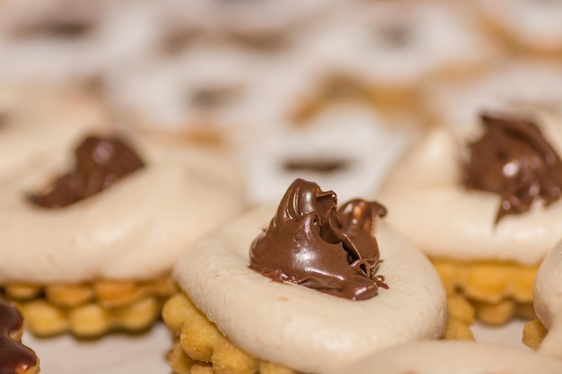 Fresh tasty christmas cookies with nougat and white foam macro