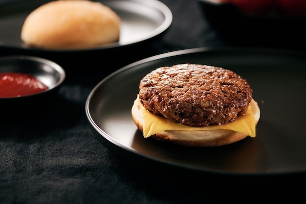 Fresh tasty homemade burger on a black plate