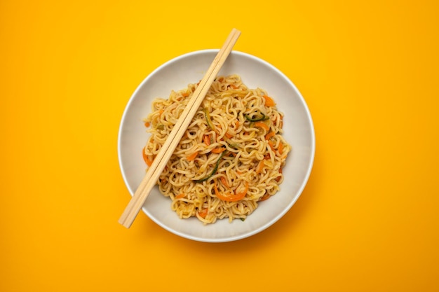 Fresh tasty noodles with vegetables in white bowl