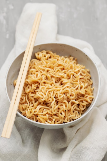 Fresh tasty noodles with vegetables in white bowl