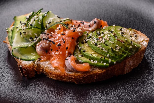 Fresh tasty sandwich with salmon avocado and sesame and flax seeds