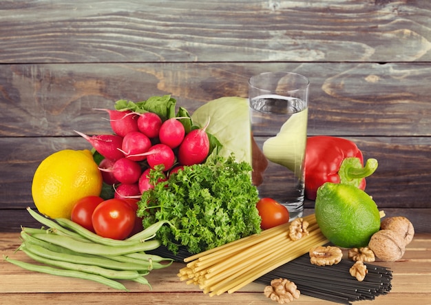 Fresh tasty vegetables with water on background