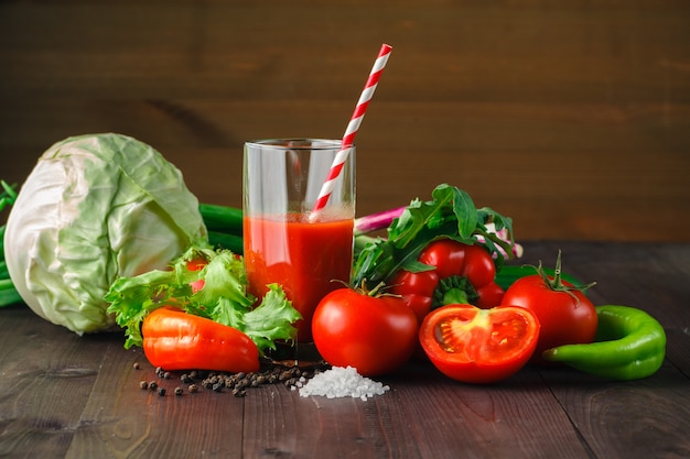 Fresh tomato juice on the rustic table.