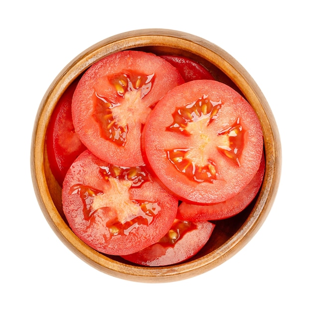 Fresh tomato slices in a wooden bowl