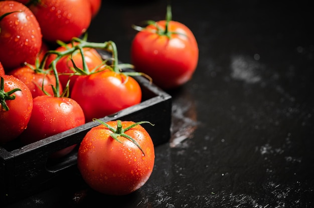 Fresh tomatoes On a black table