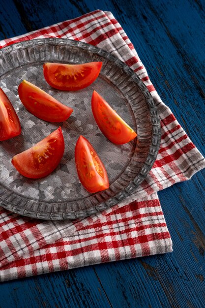 Fresh tomatoes in rustic style on a blue wooden background