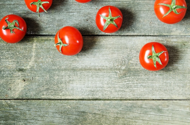 Fresh tomatoes on rustic wooden background 