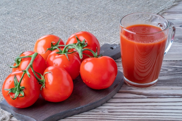 Fresh tomatoes tomato juice with salt cup with juice tomatoes on the background