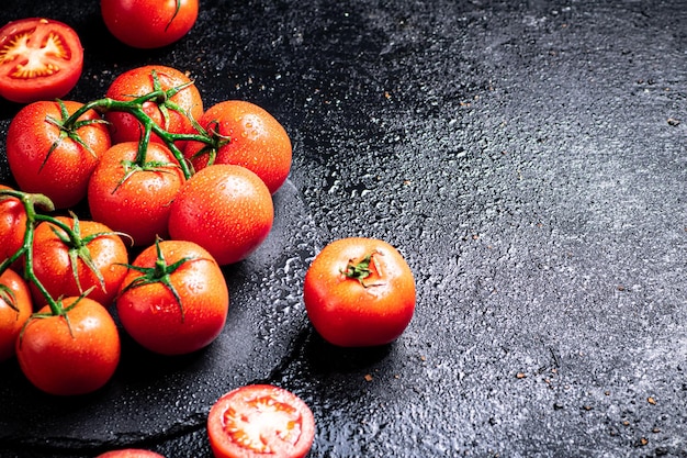 Fresh tomatoes and tomato slices on the table