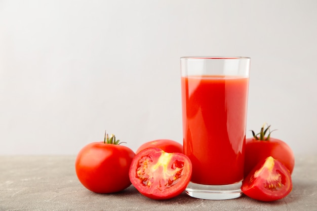 Fresh tomatoes with juice in a tall glass