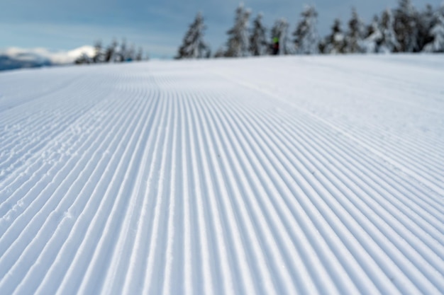 Fresh tracks of snowcat at the ski resort slopes