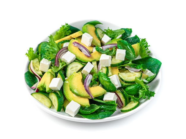 Fresh vegetable salad with avocado cucumber fresh herbs and cheese isolated on a white background Healthy food Side view