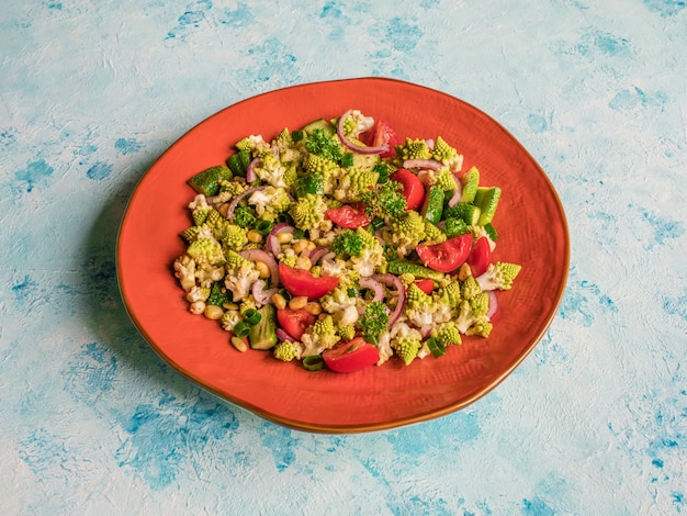 Fresh vegetable salad with cabbage romanesco and olive oil. Top view.