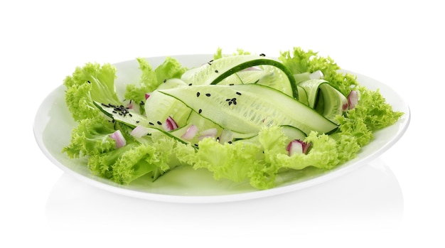 Fresh vegetable salad with cucumbers on plate isolated on white