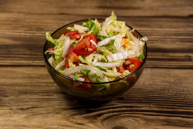 Fresh vegetable salad on wooden table