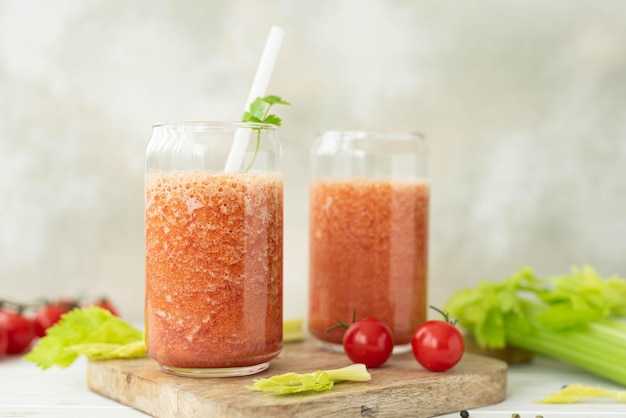 Fresh vegetable smoothie from tomatoes and celery in a glass jar