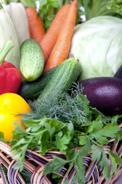 Fresh vegetables in a basket on white