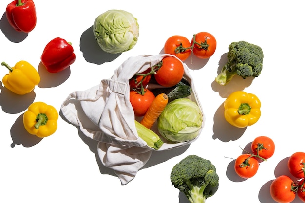 Fresh vegetables in a bio bag on a white background Top view flat lay