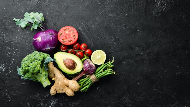 Fresh vegetables on a black background Vegetarian food Top view Free space for your text