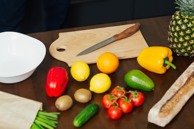 Fresh vegetables fruits knife and cutting board for cooking dinner