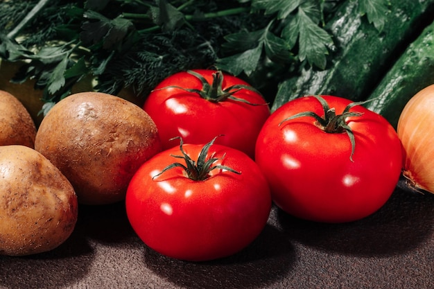 Fresh vegetables and greens on a brown background still life