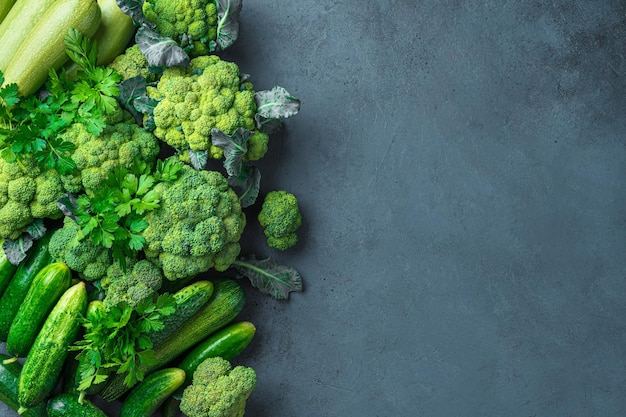 Fresh vegetables and greens on a dark background Assortment of vegetables