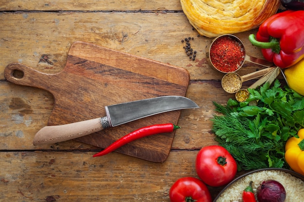 Fresh vegetables and healthy ingredients, knife on cutting board