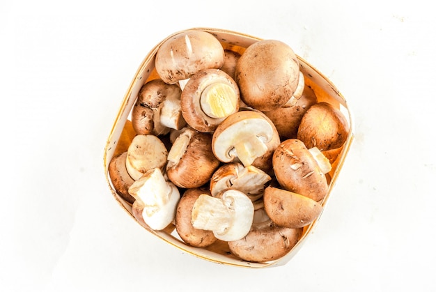 Fresh vegetables raw whole and cut brown mushrooms on white background isolation  