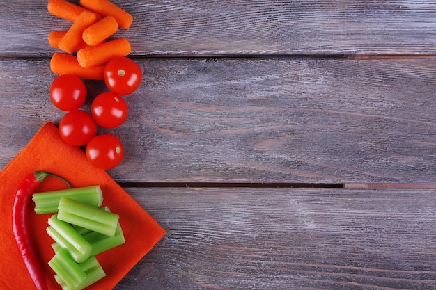 Fresh vegetables on rustic wooden planks background