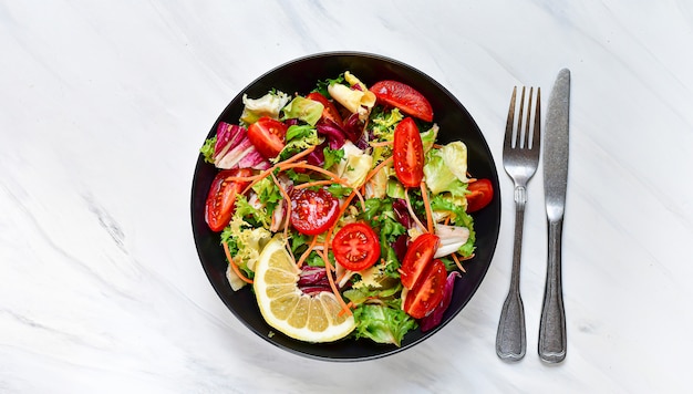 fresh vegetables salad from tomato, spinach, lettuce, onion and paprika