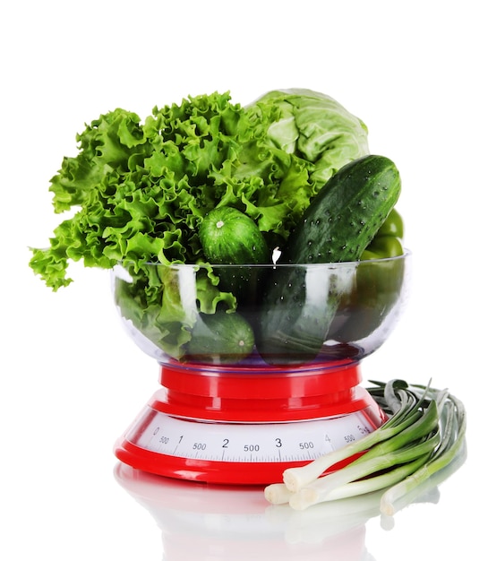 Fresh vegetables in scales isolated on white