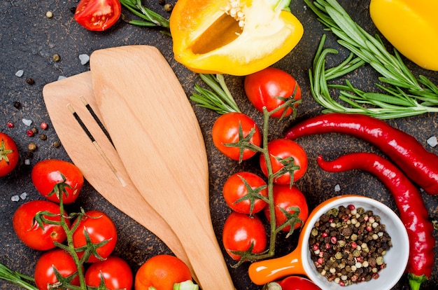 Fresh vegetables spices herbs Ingredients for healthy cooking or salad making on dark rustic background with space for your text. Top view