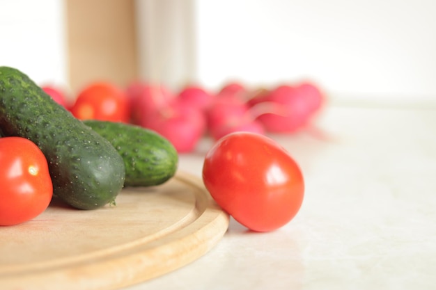 Fresh vegetables on the table selective focus Tomatoes cucumbers and radishes