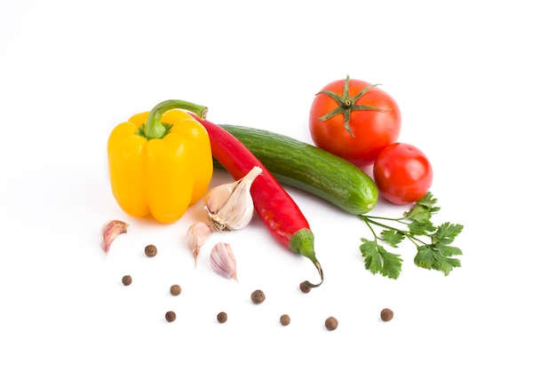 Fresh vegetables on a white background.Yellow pepper, green cucumber, red tomato and bitter pepper on a white background.