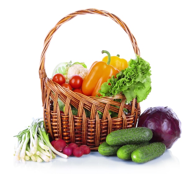 Fresh vegetables in wicker basket isolated on white