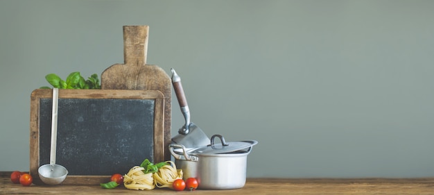 Fresh vegetables with board on wooden table