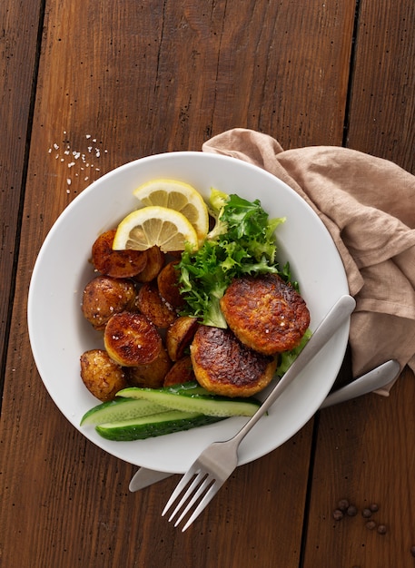 Fresh vegetarian cutlets with new potatoes and salad