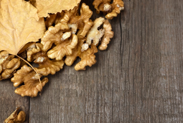 Fresh walnuts kernels on dark wooden.