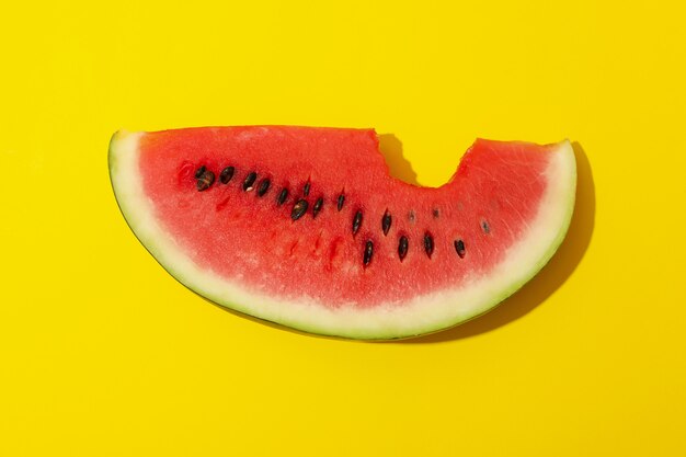 Fresh watermelon slice on yellow. Summer fruit