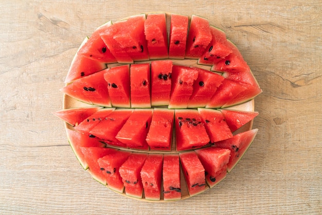 fresh watermelon sliced on wooden plate