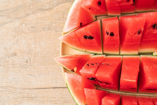 fresh watermelon sliced on wooden plate