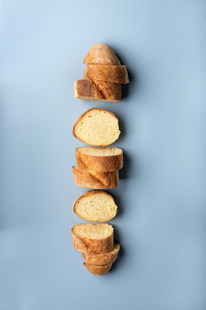 Fresh wheat flour baguette on a blue background