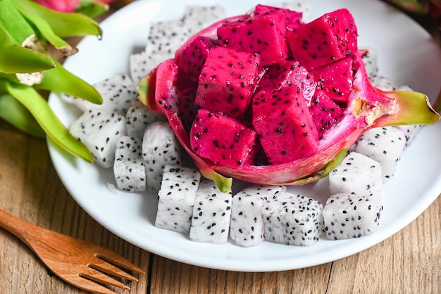 Fresh white and pink red purple dragon fruit tropical in the asian thailand healthy fruit concept dragon fruit slice on white plate with pitahaya background