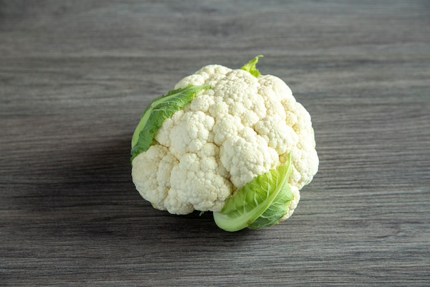 Fresh whole cauliflower on a wooden table. Healthy eating.