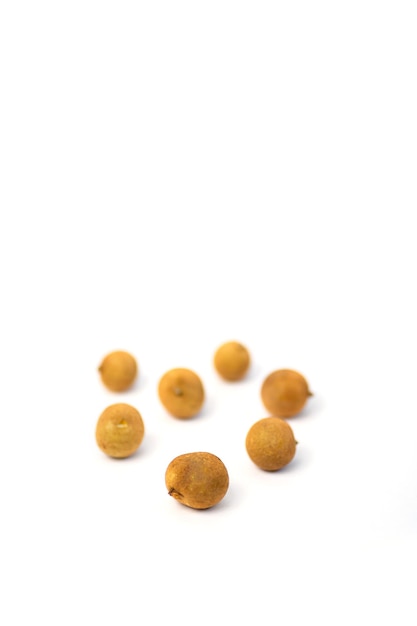 Fresh whole longan fruits isolated on white background. Exotic asian fruits. Selective focus.