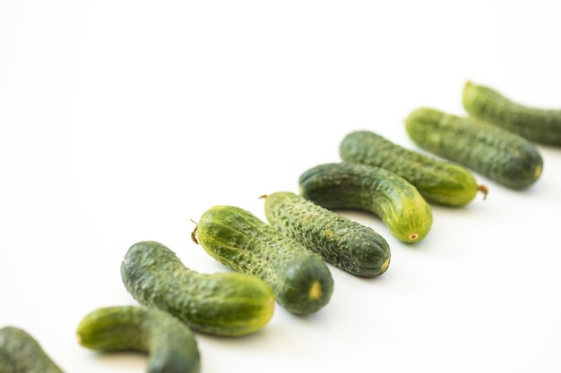 Fresh whole ripe cucumbers as background closeup