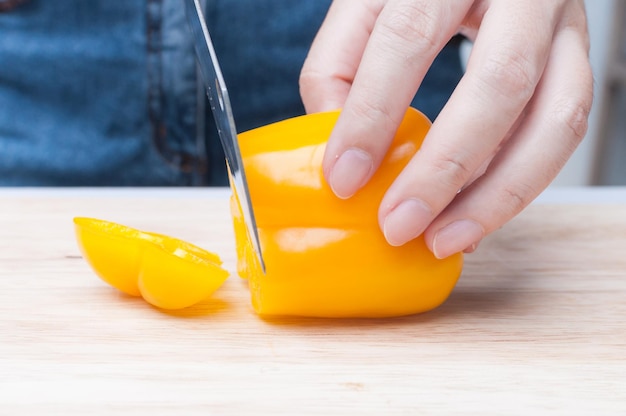 Fresh Yellow bell pepper sliced on wooden board