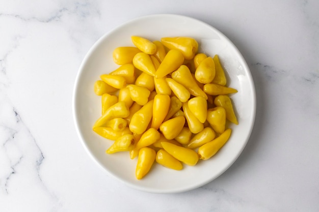 Fresh yellow chubby hot pepper pickle isolated on white background, marinated or canned peppers